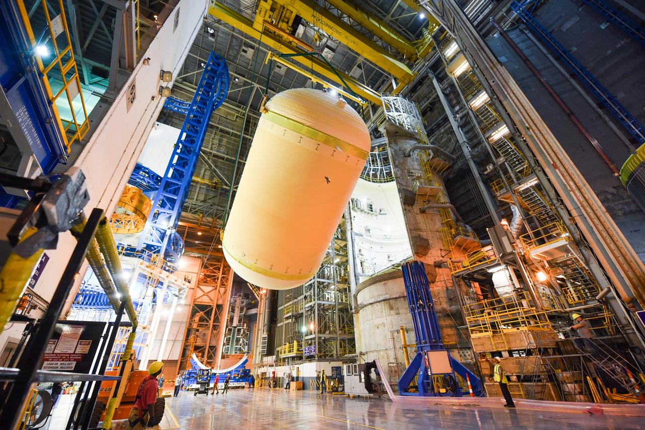 The Space Launch System (SLS) rocket’s liquid oxygen tank structural test article was manufactured and stacked in June 2019 at NASA’s Michoud Assembly Facility in New Orleans. To construct the test article, Boeing technicians at Michoud moved the liquid oxygen tank to the Vertical Assemby Building stacking and integration area. Here, they added simulators to mimic the two structures that connect to the tank, the intertank and the forward skirt.  This structural hardware for the SLS core stage for America’s new deep space rocket is structurally identical to the flight version of the tank. It will be shipped on the Pegasus barge to NASA’s Marshall Space Flight Center in Hunstville, Alabama, where it will undergo a series of tests that simulate the stresses and loads of liftoff and flight. These tests will help ensure designs are adequate for successful SLS missions to the Moon and beyond. The flight liquid oxygen tank along with the liquid hydrogen tank supplies more than 500,000 gallons of propellant to the core stages four RS-25 engines, which produce 2 million pounds of thrust to help send the SLS rocket to space.